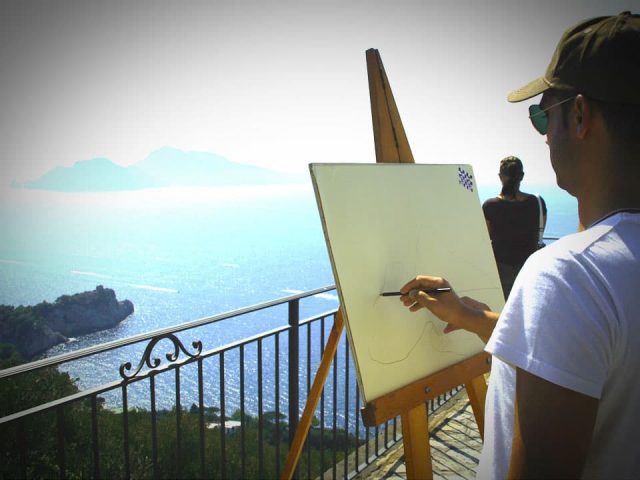 man painting scenery